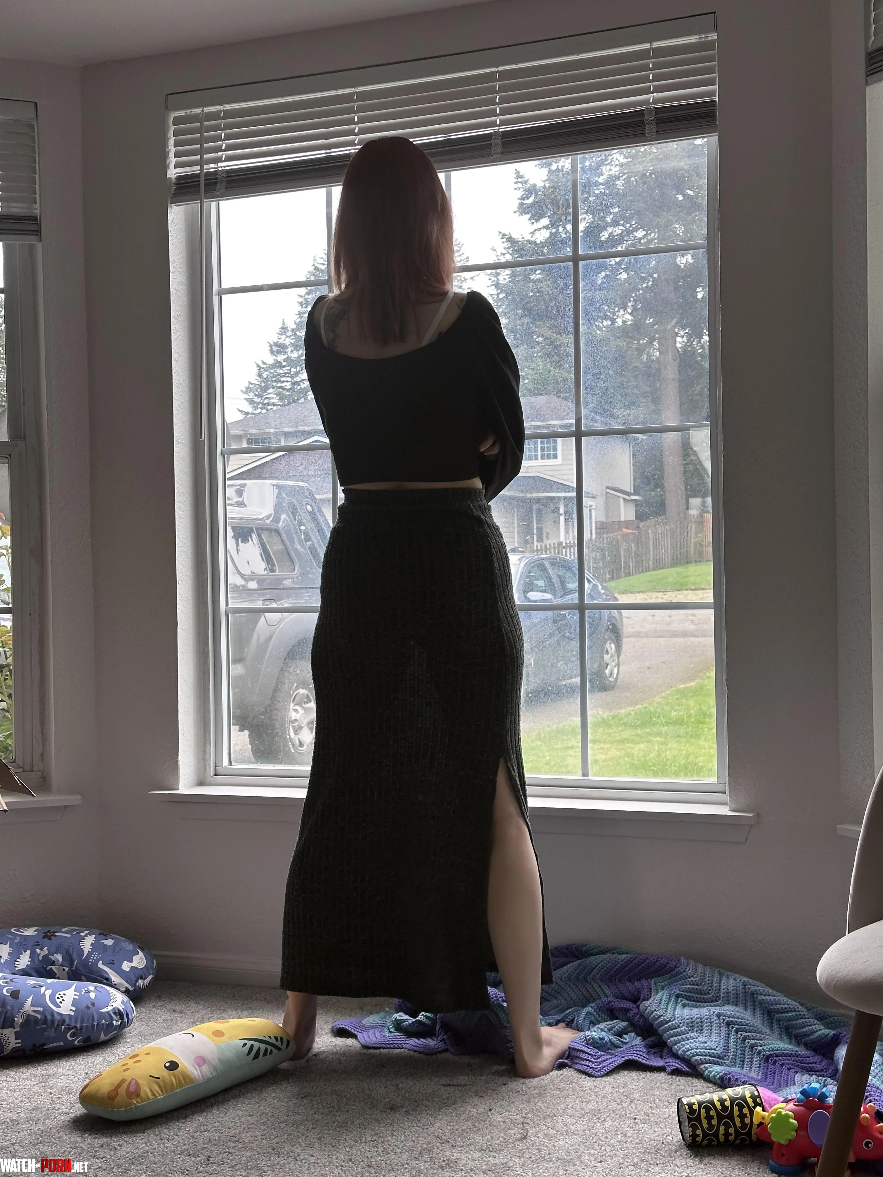 My wife standing at our window. by AdSmooth8332