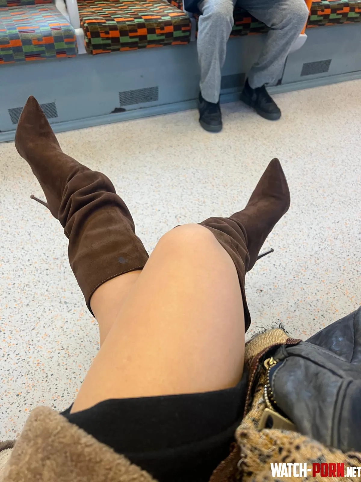 enjoying my knee high boots on the train by MalinaWhispers